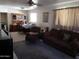 Cozy living room with comfortable seating, ceiling fan, and adjoining dining area at 4223 E Earll Dr, Phoenix, AZ 85018