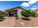 Charming backyard with a covered patio, tiled walkway, and lush landscaping creating a peaceful outdoor oasis at 4321 E Rowel Rd, Phoenix, AZ 85050