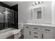 Charming bathroom with vanity, framed mirror, and a shower-tub combination with glass doors at 4321 E Rowel Rd, Phoenix, AZ 85050
