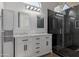 Updated bathroom with double sinks, marble countertops, and a glass-enclosed shower at 4321 E Rowel Rd, Phoenix, AZ 85050