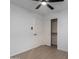 Bright bedroom with wood-look floors, a ceiling fan, closet, and an entryway at 4321 E Rowel Rd, Phoenix, AZ 85050