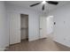 Cozy bedroom featuring wood-look floors, a ceiling fan, and a closet at 4321 E Rowel Rd, Phoenix, AZ 85050