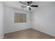 Neat bedroom featuring wood-look floors, a ceiling fan, and a window for natural light at 4321 E Rowel Rd, Phoenix, AZ 85050