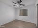Clean bedroom featuring wood-look floors, a ceiling fan, and a window for natural light at 4321 E Rowel Rd, Phoenix, AZ 85050