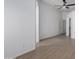 Bright bedroom featuring wood-look floors, a ceiling fan, and access to a walk-in closet at 4321 E Rowel Rd, Phoenix, AZ 85050