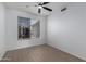Bright bedroom featuring wood-look floors, a ceiling fan, and a sunny window at 4321 E Rowel Rd, Phoenix, AZ 85050