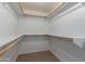 Walk-in closet with ample shelving and wooden rods for maximum storage solutions at 4321 E Rowel Rd, Phoenix, AZ 85050