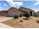 Charming single-story home with desert landscaping, an attached two-car garage, and a neutral color scheme at 4321 E Rowel Rd, Phoenix, AZ 85050