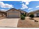 A charming, single story home with an attached two-car garage and desert landscaping at 4321 E Rowel Rd, Phoenix, AZ 85050