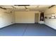 Spacious garage featuring painted floor, storage shelves, and water heater at 4321 E Rowel Rd, Phoenix, AZ 85050