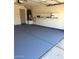 Garage featuring painted floor, storage shelves, and water heater at 4321 E Rowel Rd, Phoenix, AZ 85050