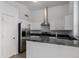 Modern kitchen featuring stainless steel appliances, granite countertops, and white cabinets at 4321 E Rowel Rd, Phoenix, AZ 85050