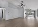 Spacious living room featuring wood-look floors, white walls, and modern ceiling fan at 4321 E Rowel Rd, Phoenix, AZ 85050
