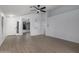 Bright living room with wood-look floors, white walls, ceiling fan, and neutral decor at 4321 E Rowel Rd, Phoenix, AZ 85050