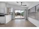 Open concept living area with wood-look floors, ceiling fan, and sliding doors to the backyard at 4321 E Rowel Rd, Phoenix, AZ 85050