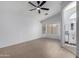 Main bedroom featuring wood-look floors, white walls, a ceiling fan, and a large window at 4321 E Rowel Rd, Phoenix, AZ 85050