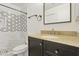Modern bathroom featuring a dark vanity with granite countertops and a walk-in shower with decorative tiling at 440 N New Hvn, Mesa, AZ 85205