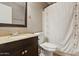 Cozy bathroom featuring a vanity with a granite countertop and a shower with a patterned curtain at 440 N New Hvn, Mesa, AZ 85205
