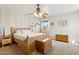 Bright bedroom featuring a natural wood bed frame and matching dressers with a unique ceiling fan at 440 N New Hvn, Mesa, AZ 85205