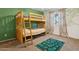 bedroom with bunk beds, a decorative rug, and a green accent wall, creating a fun and inviting space at 440 N New Hvn, Mesa, AZ 85205