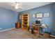 Bedroom with blue walls, neutral carpet, and light wood furnishings including a desk, bookcase, and filing cabinet at 440 N New Hvn, Mesa, AZ 85205