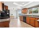 Spacious kitchen featuring tile floors, a ceiling fan, granite countertops, and light wood cabinetry at 440 N New Hvn, Mesa, AZ 85205
