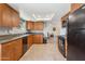 Functional kitchen featuring granite countertops, wood cabinets, and black appliances at 440 N New Hvn, Mesa, AZ 85205