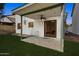 Outdoor patio with a ceiling fan and sliding glass doors, offering a great transition to the backyard and green lawn at 440 N New Hvn, Mesa, AZ 85205