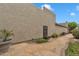 Desert home's private flagstone patio, accentuated by potted plants and lush landscaping at 4545 E Wescott Dr, Phoenix, AZ 85050
