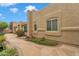 Desert home with a flagstone patio, framed by flower beds and lush landscaping at 4545 E Wescott Dr, Phoenix, AZ 85050