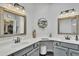 A beautifully designed bathroom featuring double sinks, decorative mirrors and cabinetry, with modern fixtures at 4545 E Wescott Dr, Phoenix, AZ 85050