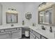 A beautifully designed bathroom featuring double sinks, decorative mirrors and cabinetry, with modern fixtures at 4545 E Wescott Dr, Phoenix, AZ 85050