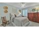 A serene bedroom features a neutral color palette, ceiling fan, plantation shutters and a cozy bed, creating a relaxing retreat at 4545 E Wescott Dr, Phoenix, AZ 85050