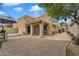 Home's exterior features a covered patio, stone accents, and desert landscaping, blending style with practicality at 4545 E Wescott Dr, Phoenix, AZ 85050