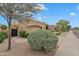 Tan home with a two-car garage and iron gate, complemented by desert landscaping and a blue sky at 4545 E Wescott Dr, Phoenix, AZ 85050