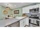 Open-concept kitchen with stainless appliances and grey countertops, perfect for entertaining at 4545 E Wescott Dr, Phoenix, AZ 85050