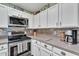 Kitchen with stainless steel appliances, white cabinets, and ample counter space at 4545 E Wescott Dr, Phoenix, AZ 85050