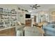 Spacious living room with hardwood floors, built-in bookshelves, and an open layout to the kitchen at 4545 E Wescott Dr, Phoenix, AZ 85050