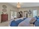 A cozy main bedroom features neutral walls and cool blue bedding, access to the outdoors, and stylish accents at 4545 E Wescott Dr, Phoenix, AZ 85050