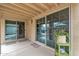 Relaxing covered patio space featuring sliding glass doors, neutral decor, and potted plants at 4545 E Wescott Dr, Phoenix, AZ 85050