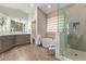 Bright bathroom featuring double sinks, modern shower, soaking tub, and neutral color palette at 4584 W Detroit St, Chandler, AZ 85226