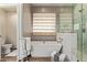 A soaking tub with a window view, and a glass-enclosed shower offering a modern bathroom experience at 4584 W Detroit St, Chandler, AZ 85226