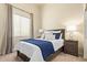 Cozy bedroom with a plush bed, complemented by modern bedside lamps and a window for natural light at 4584 W Detroit St, Chandler, AZ 85226