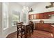 Dining area featuring hardwood floors, natural light from the large window, and adjacent to kitchen cabinets at 4584 W Detroit St, Chandler, AZ 85226