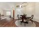Elegant dining room featuring wood floors, a chandelier, and views of the living area at 4584 W Detroit St, Chandler, AZ 85226