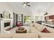 Open-concept living room with a fireplace, comfortable seating, and views of the backyard pool at 4584 W Detroit St, Chandler, AZ 85226