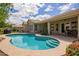 Beautiful backyard oasis featuring a swimming pool with built-in steps and covered patio area at 4584 W Detroit St, Chandler, AZ 85226