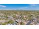 Expansive aerial shot of a desert neighborhood with blue skies and mountain views in the distance at 4706 E Rancho Caliente Dr, Cave Creek, AZ 85331