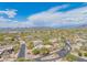 Wide aerial view highlights a desert home with beautiful landscaping and a tile roof in a desert community at 4706 E Rancho Caliente Dr, Cave Creek, AZ 85331