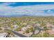 Sweeping aerial shot captures a desert home with solar panels, nestled in a lush, arid landscape at 4706 E Rancho Caliente Dr, Cave Creek, AZ 85331